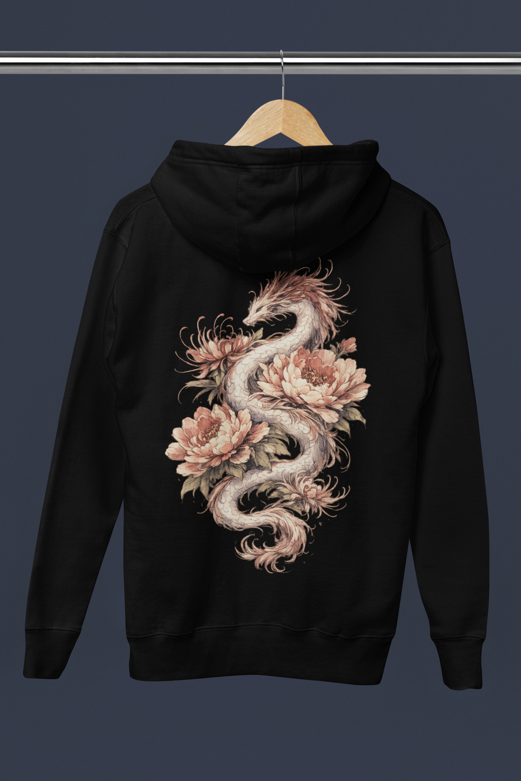 Black hoodie with a dragon and floral design on a hanger against a dark background