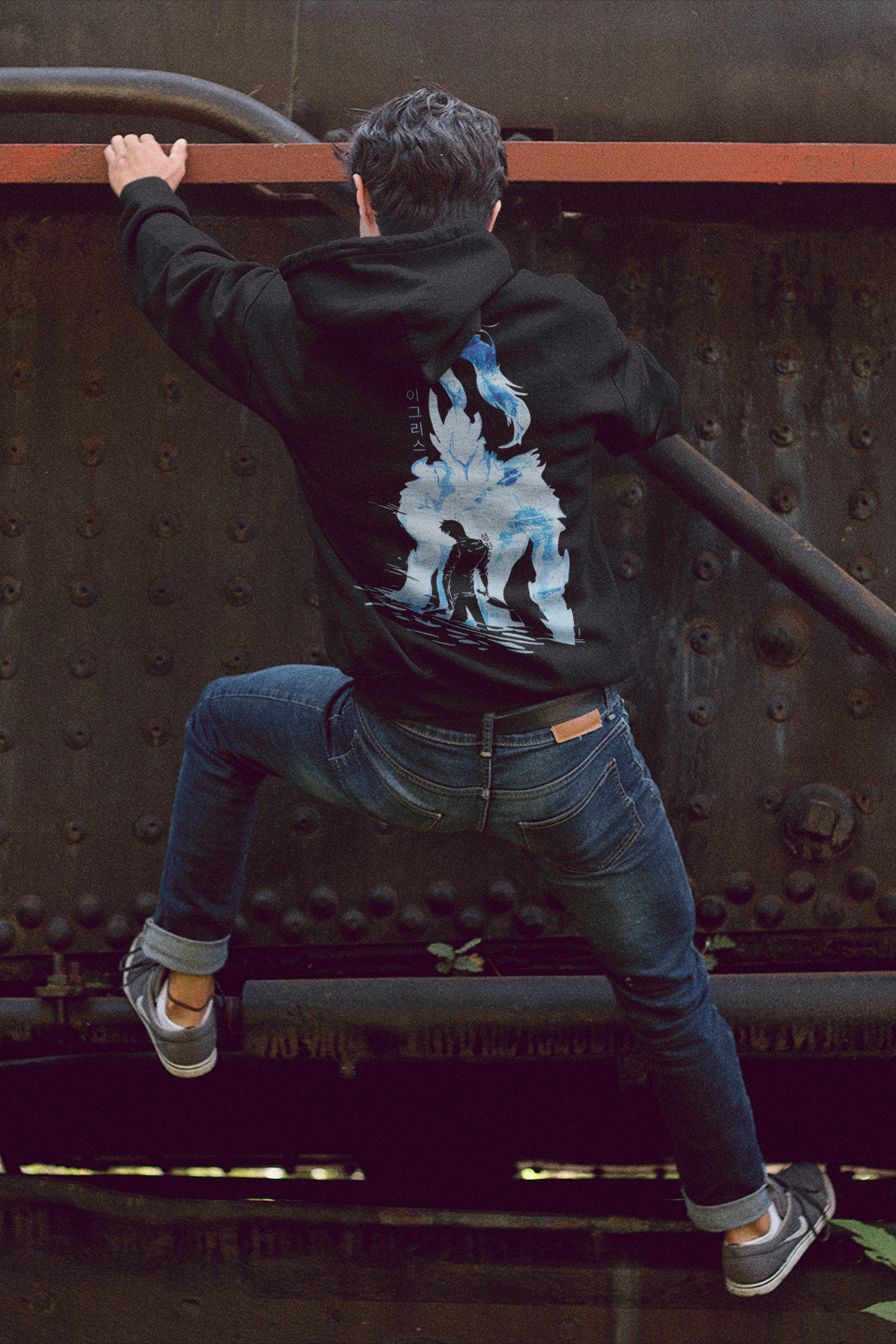 Person climbing on a large metal structure, possibly a train engine