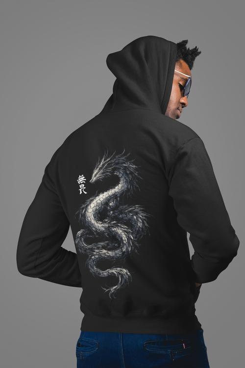 Person wearing a black hoodie with a dragon design on the back against a gray background